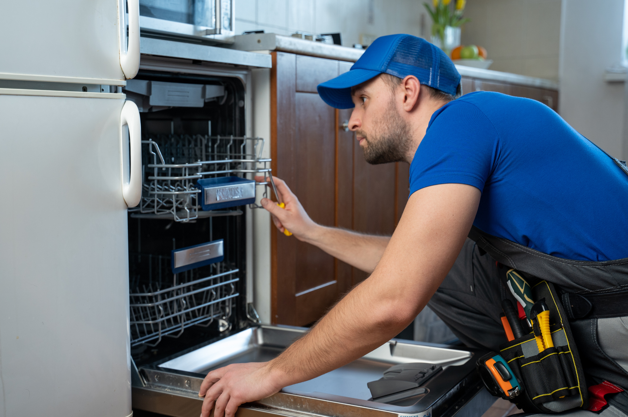 Technician fixing dishwasher; clients reach ASuperior Contact Center 24/7.