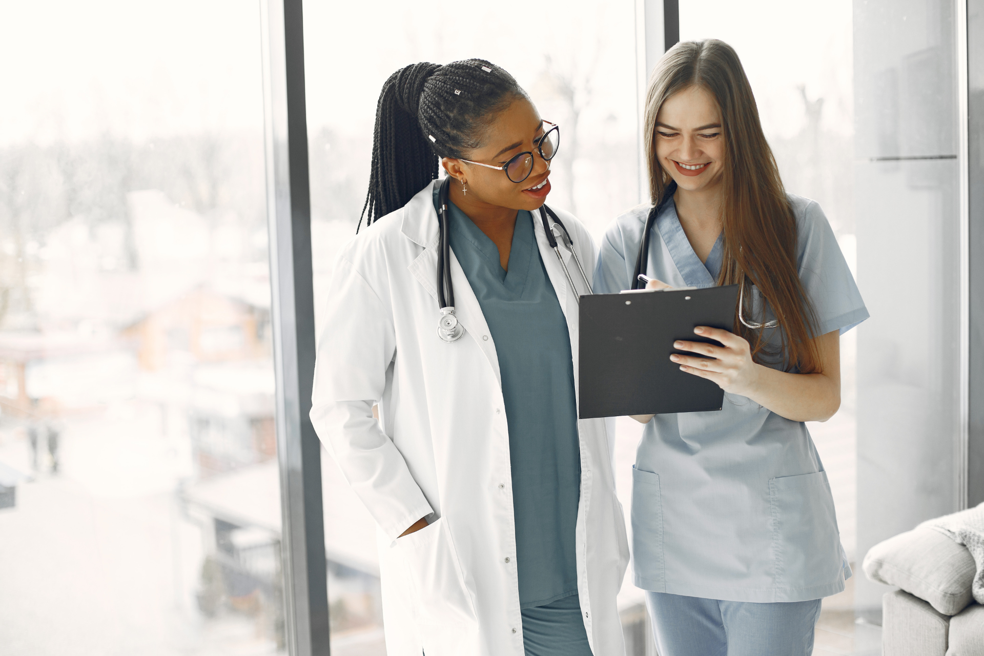 Healthcare professionals reviewing patient information on a digital tablet in a medical office