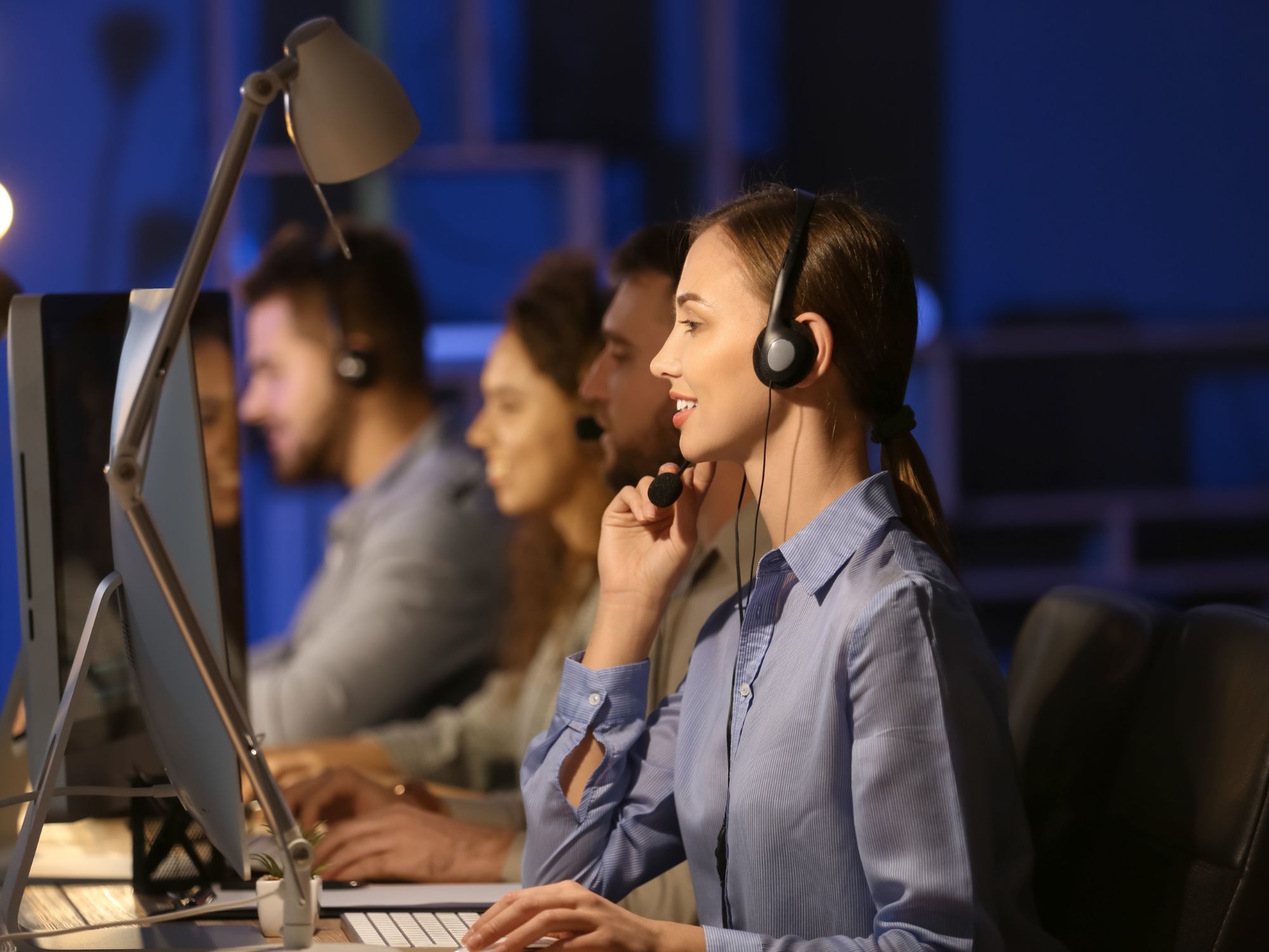 Professional call center agents wearing headsets providing 24/7 customer support and dispatching services